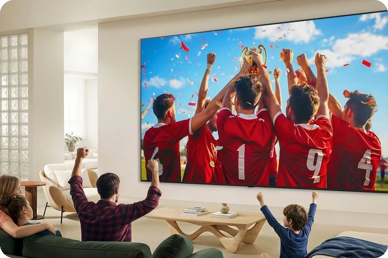 Ultra-big LG QNED evo television displaying a football match in a modern living room.