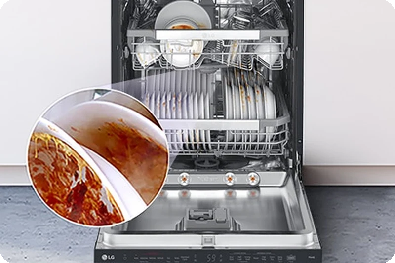 A freestanding dishwasher with the door fully open, revealing dirty dishes inside.
