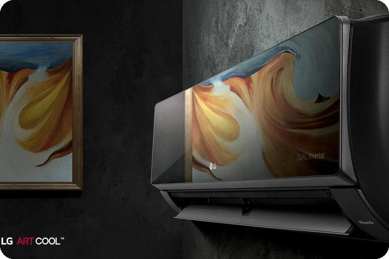 LG ARTCOOL air conditioner with a mirrored glass finish mounted on a modern interior wall.