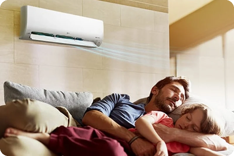 A person sleeping comfortably in a room cooled by LG air conditioning.
