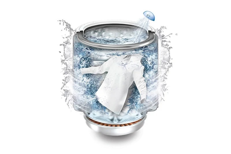 A focused jet of water spraying laundry inside the LG top-load washer.